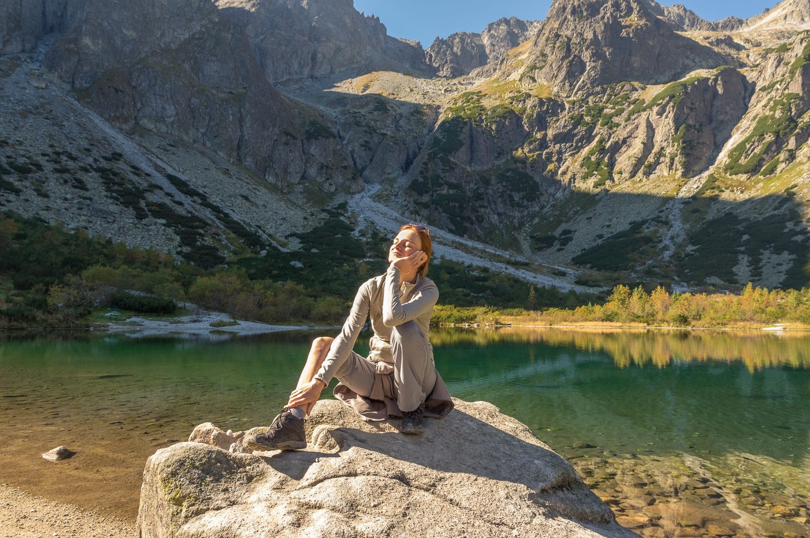 veronika sitting on a boulder by zelene pleso