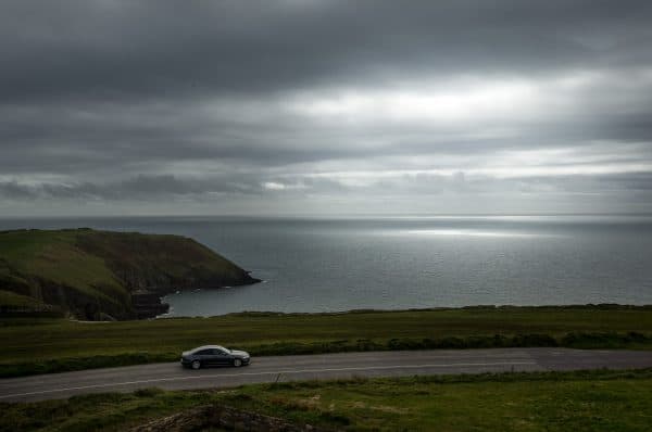 a car driving on coastal road in Cork Country near Old head of kinsale